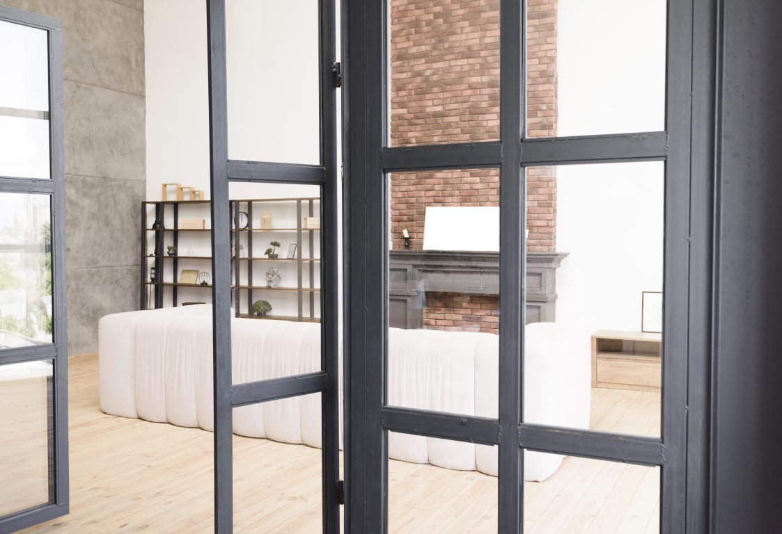 Modern aluminum and glass doors providing a sleek entrance to a home.