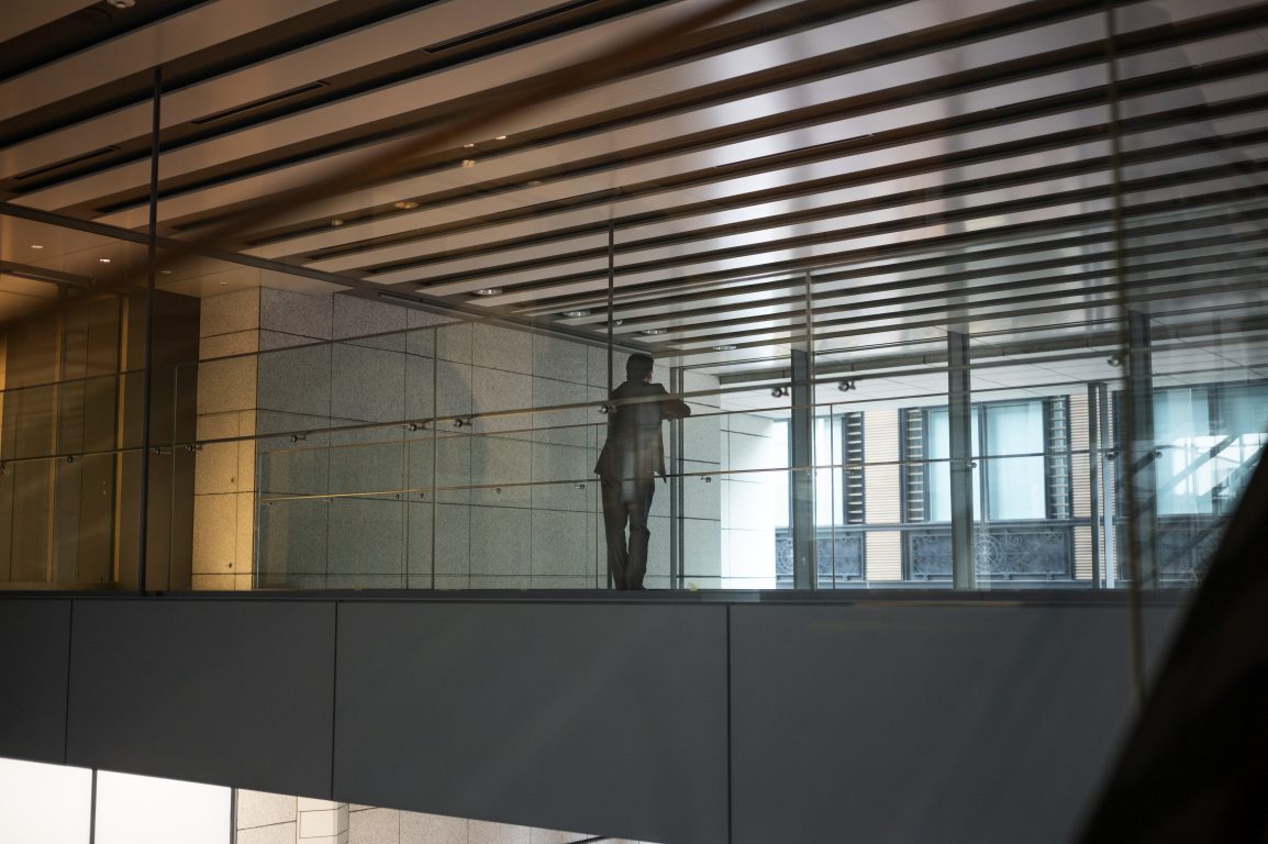 A grid of aluminum ceiling tiles with a metallic finish, featuring intricate patterns and a sleek, reflective surface, installed in a modern interior space.